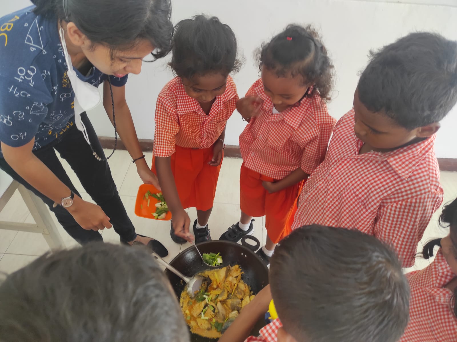 Students cooking together with teacher